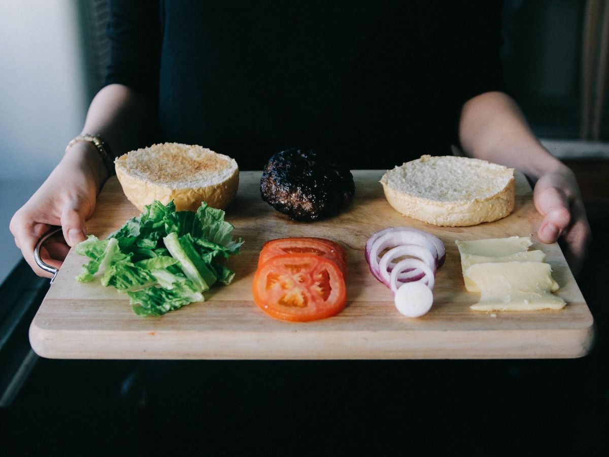 Platter of food on wooden chopping board - Restaurant marketing ideas: how to attract new customers to your restaurant - Image